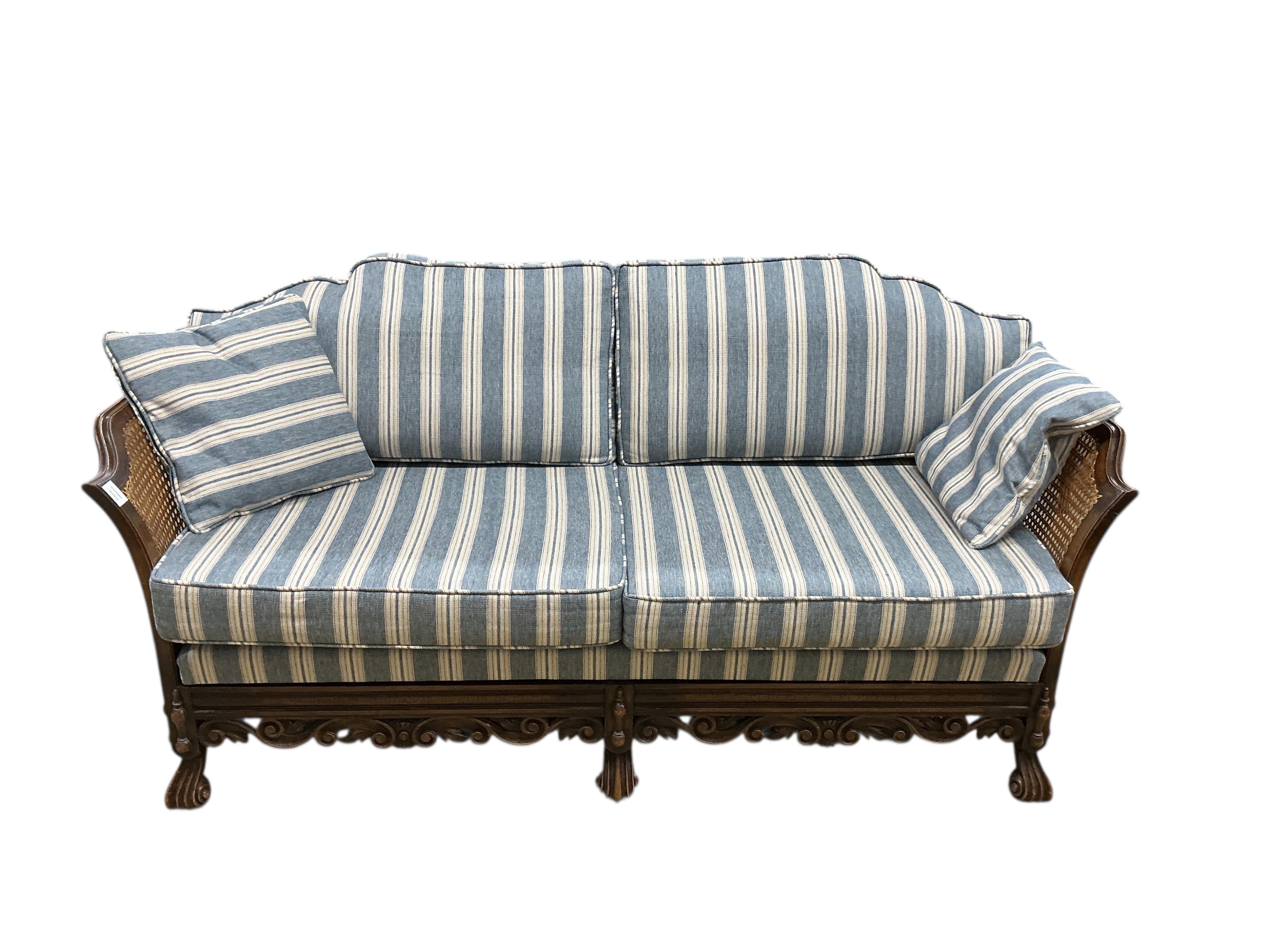 An early 20th century William & Mary style oak bergere settee, with loose cushion seat and back, width 172cm, depth 71cm, height 80cm